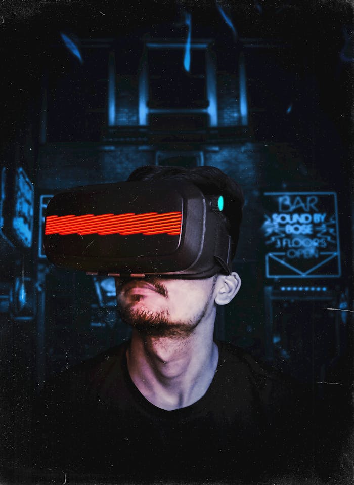 heros-img Young man immersed in a virtual reality experience using a VR headset, showcasing futuristic tech in a gaming environment.